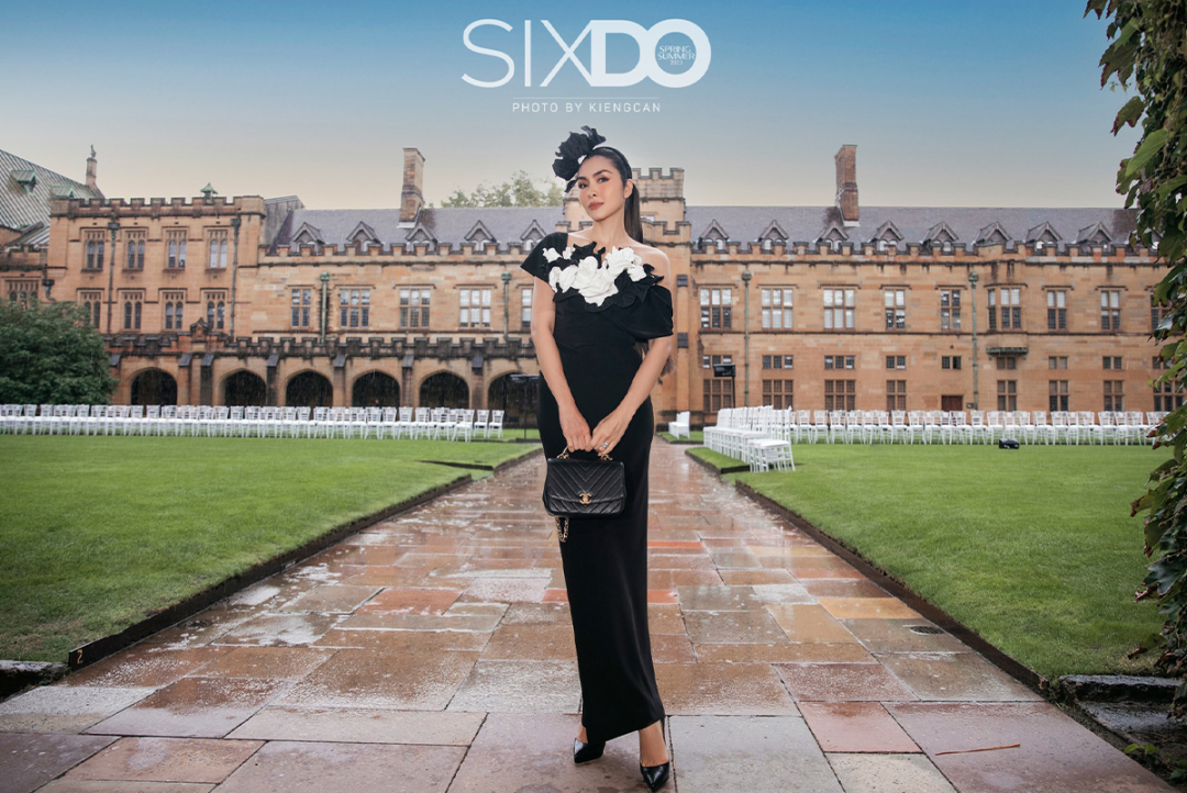 Fashionably dressed attendee in black at SIXDO fashion show in University of Sydney Quadrangle