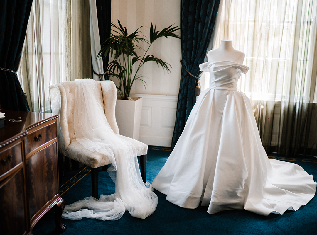 Elegant wedding dress awaiting the bride in the Chancellor's Room at the Holme Building