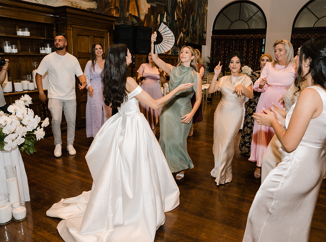 The couple joyfully engaging in a dance with the guests during the wedding reception