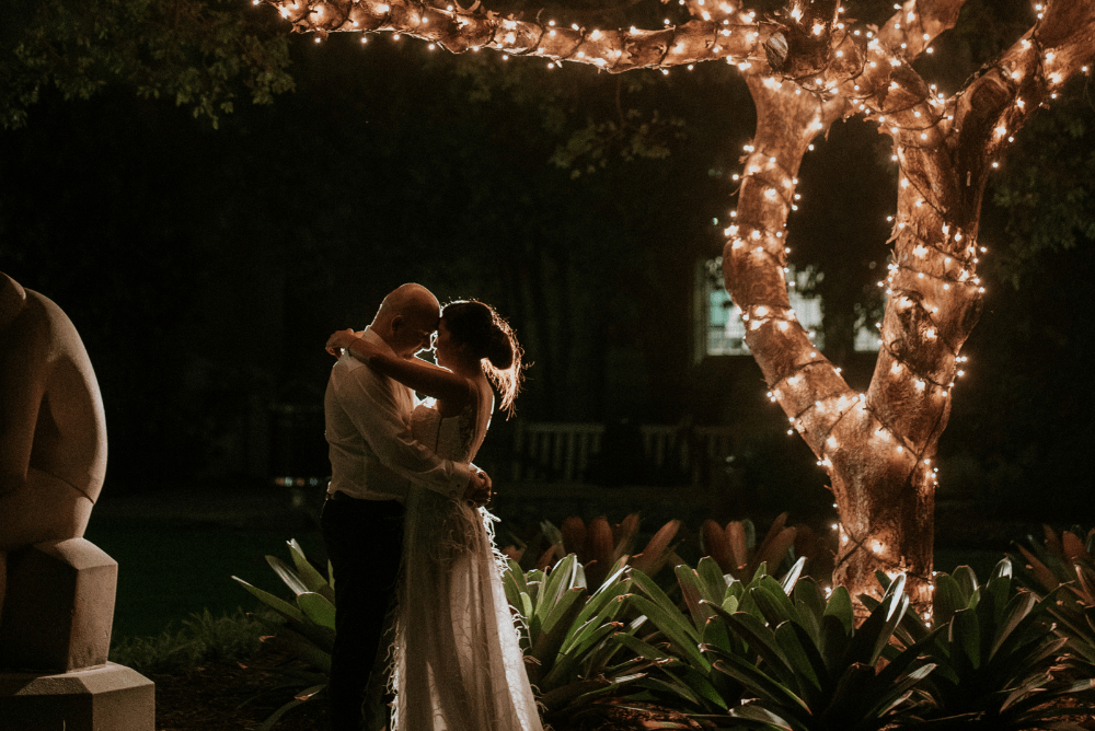 Tran and Luke under tree with fairy lights